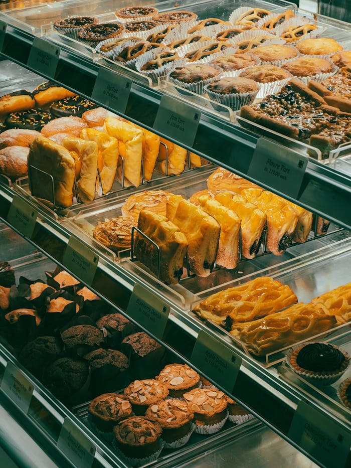 A vibrant display of assorted fresh baked goods in a bakery showcase.